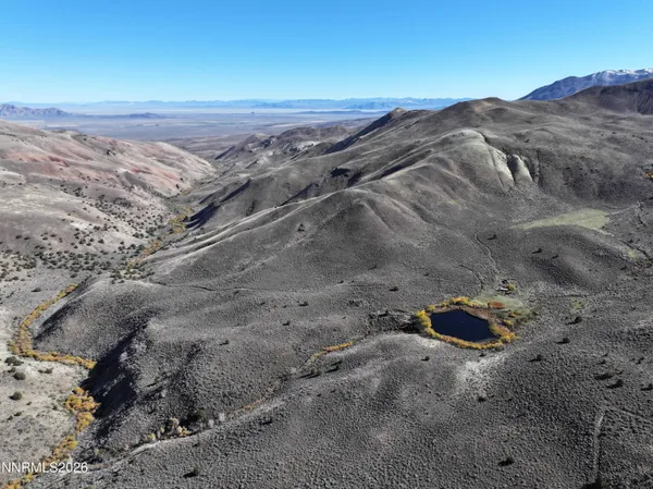 a view of a dry top with mountains in the background