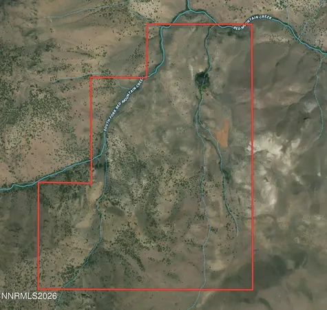 a white bed with a white comforter and pillows