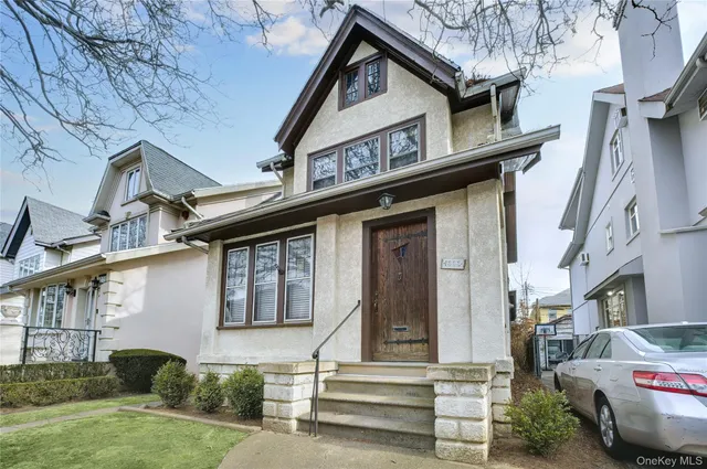 a front view of a house with a garden