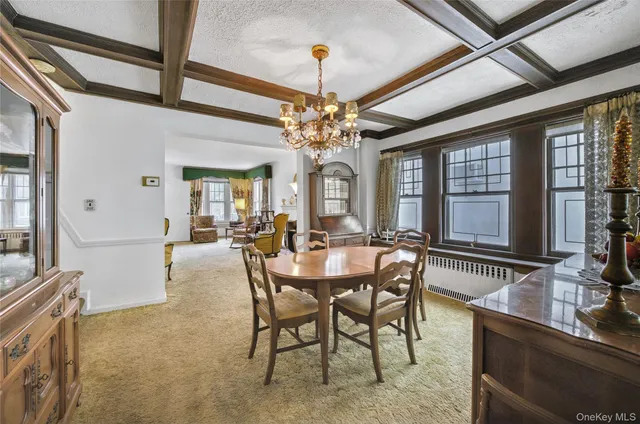 a view of a dining room with furniture and chandelier
