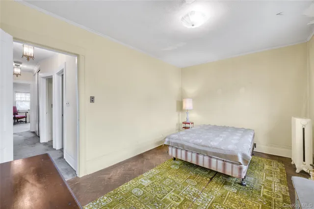 a spacious bedroom with a bed and a rug