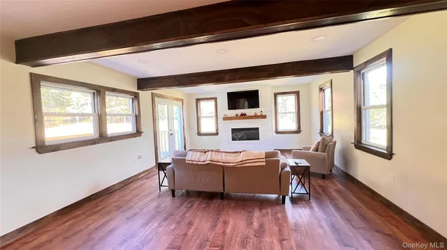 a living room with furniture fireplace and flat screen tv