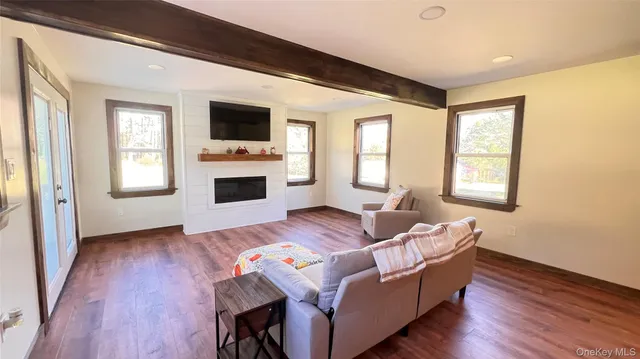 a bedroom with furniture and a wooden floor