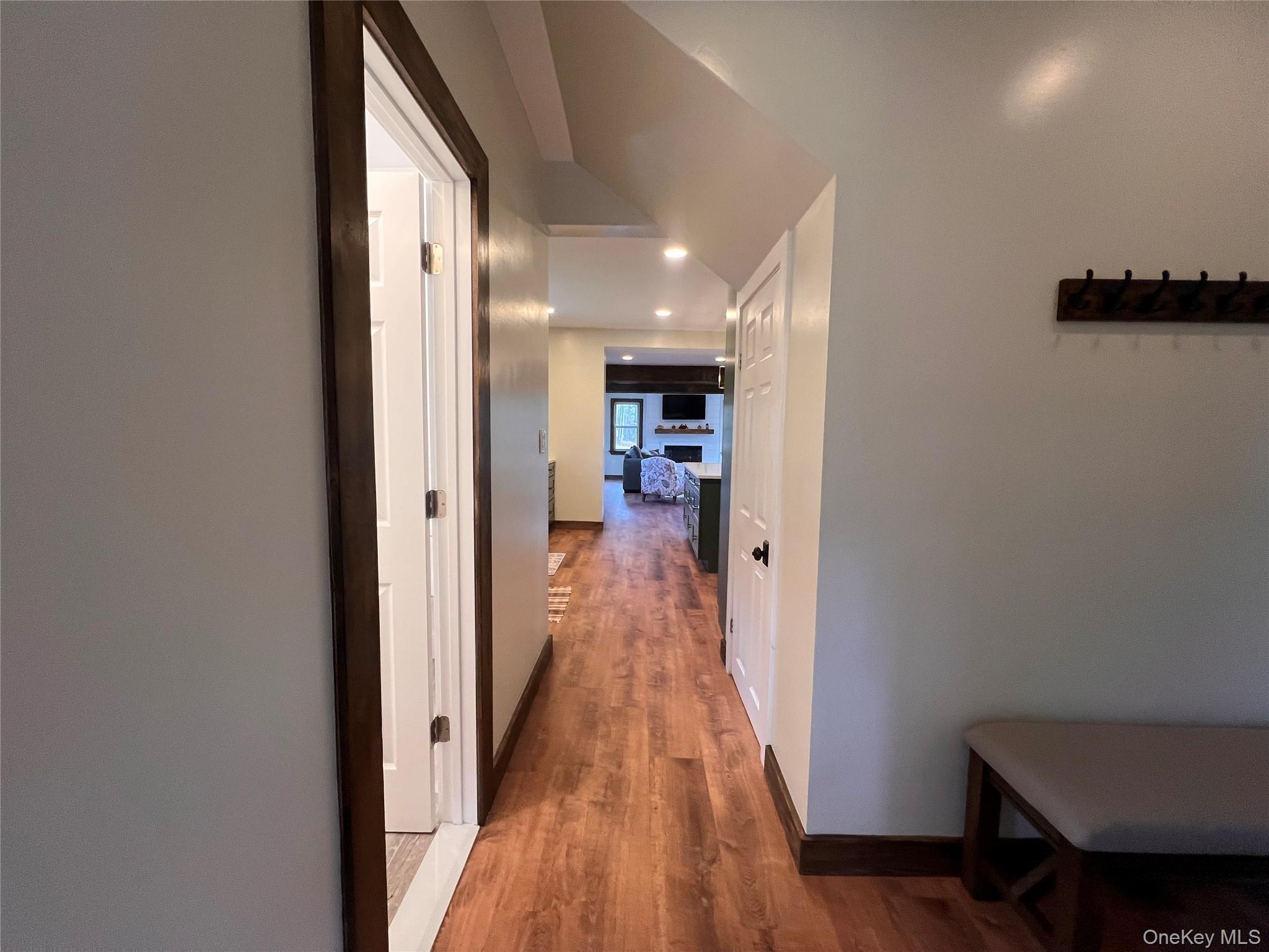 79 Dexheimer Road Narrowsburg, NY 12764 - Photo 13 of 29 a view of a hallway with wooden floor and a living room