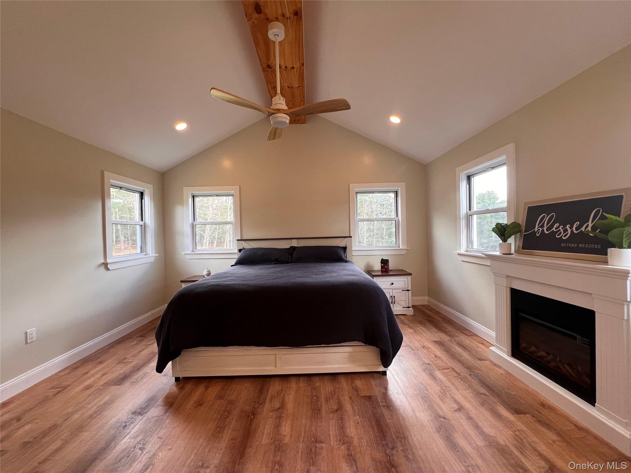 79 Dexheimer Road Narrowsburg, NY 12764 - Photo 18 of 29 Bedroom with light wood finished floors, ceiling fan, a glass covered fireplace, and recessed lighting