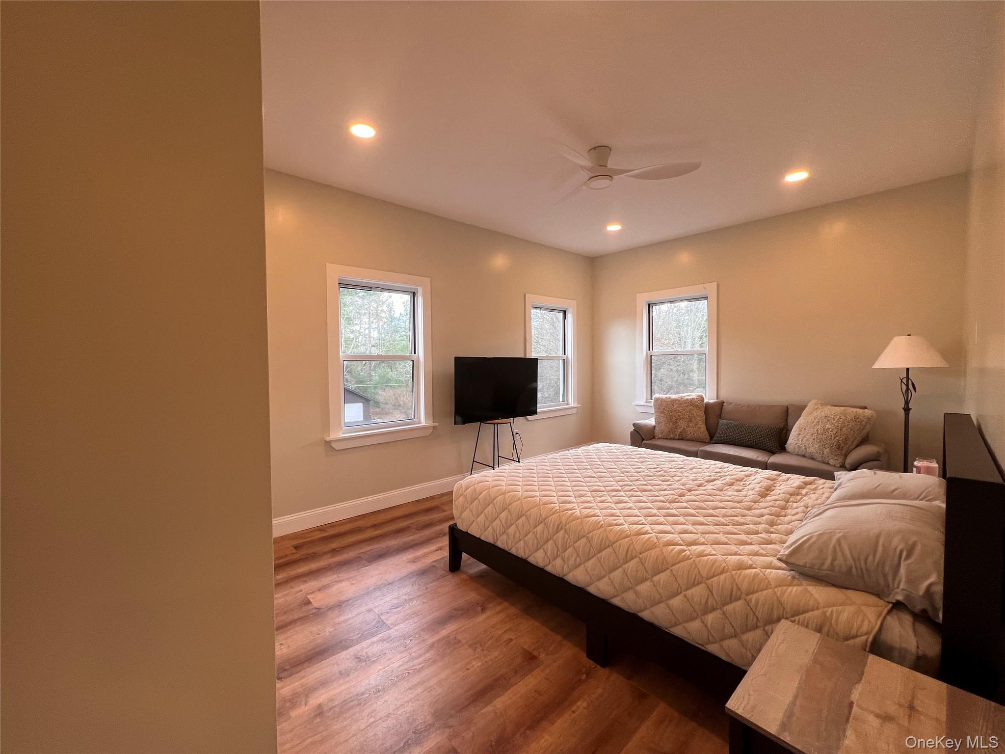 79 Dexheimer Road Narrowsburg, NY 12764 - Photo 24 of 29 Bedroom featuring wood finished floors, multiple windows, recessed lighting, and a ceiling fan