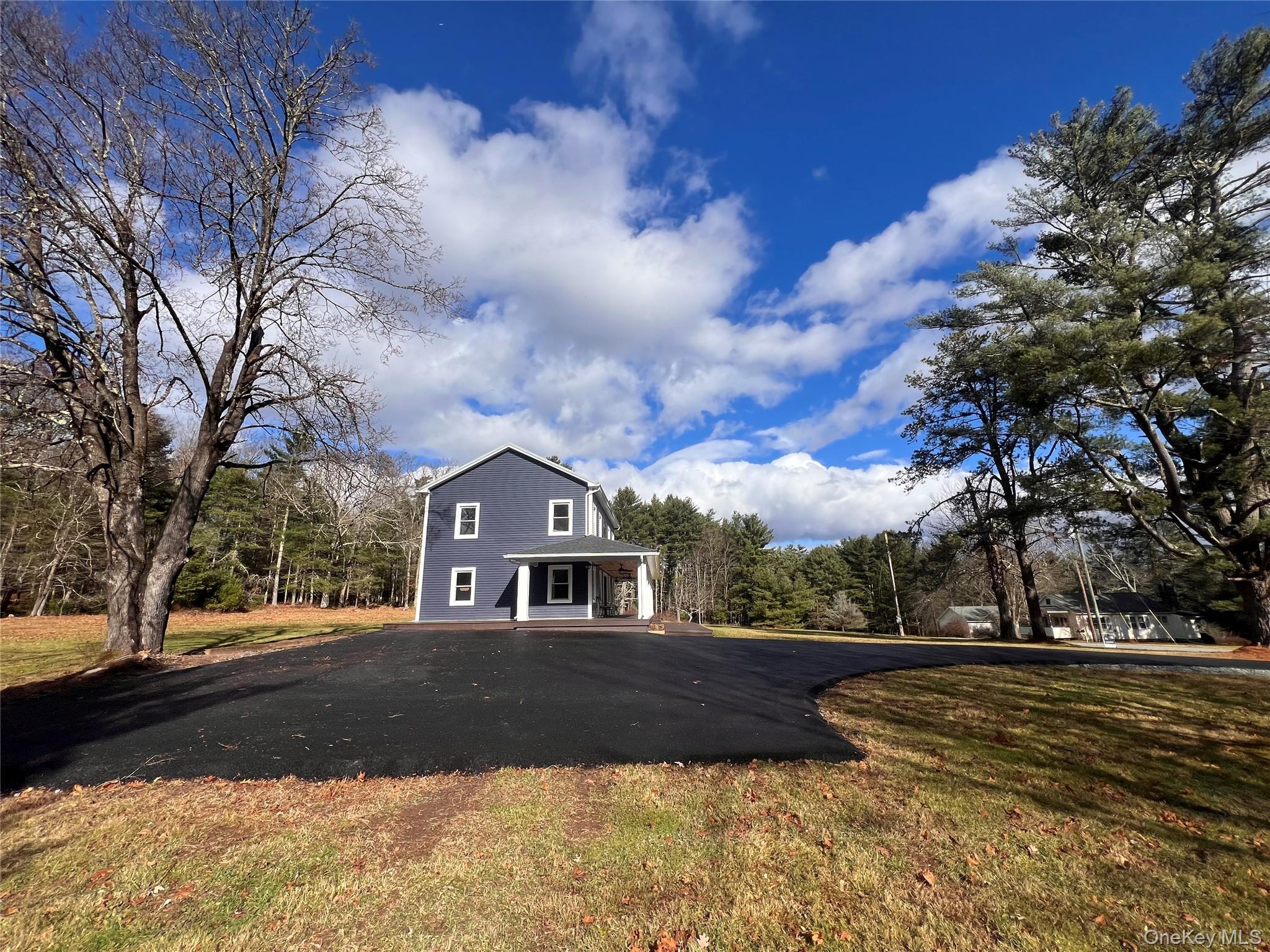 79 Dexheimer Road Narrowsburg, NY 12764 - Photo 3 of 29 View of front of property featuring covered porch, a front lawn, and a forest view