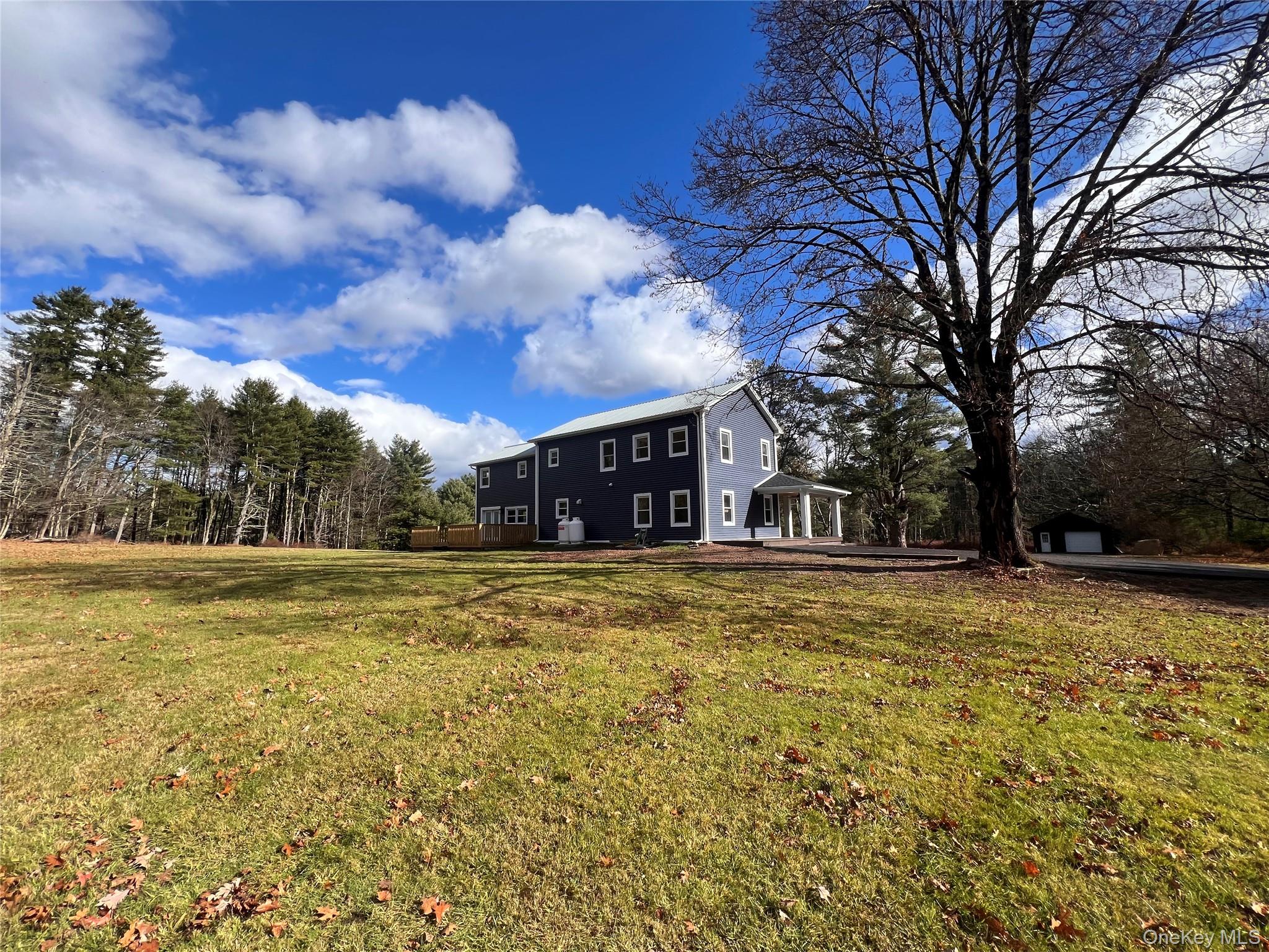 79 Dexheimer Road Narrowsburg, NY 12764 - Photo 4 of 29 a view of a yard with a house in the background