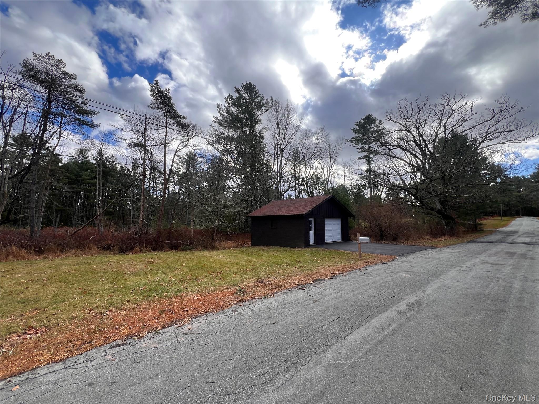 79 Dexheimer Road Narrowsburg, NY 12764 - Photo 7 of 29 a yellow house with trees in front of it