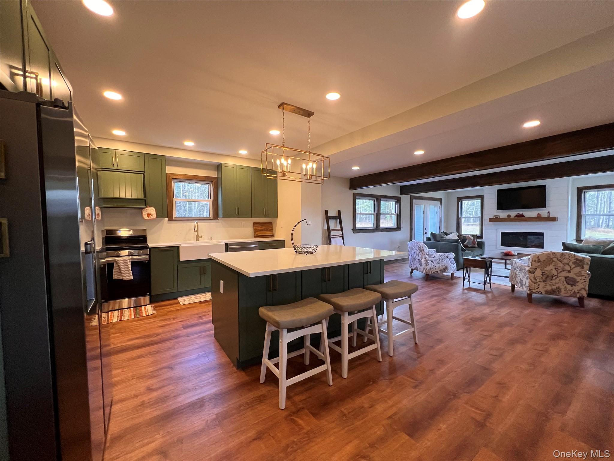 79 Dexheimer Road Narrowsburg, NY 12764 - Photo 9 of 29 a open kitchen with kitchen island granite countertop wooden floors and a view of living room