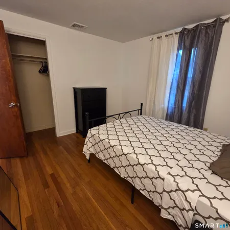 a bedroom with a bed and a mirror