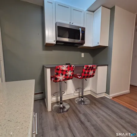 a kitchen with a wooden floor and cabinets