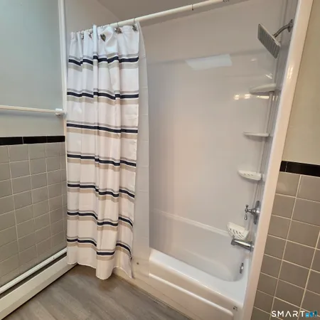 a bathroom with a bathtub and shower