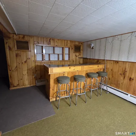 a dining room with furniture and a window