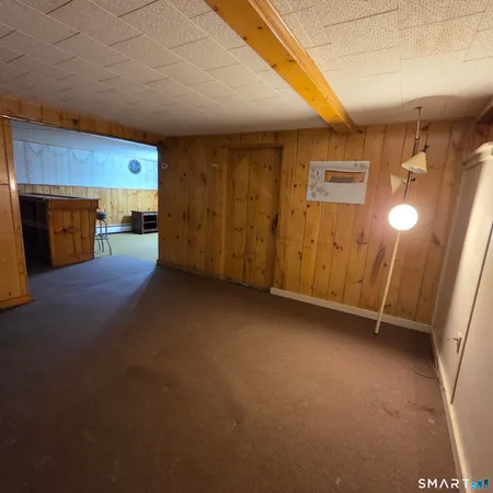 a view of a livingroom with an empty space and a fireplace