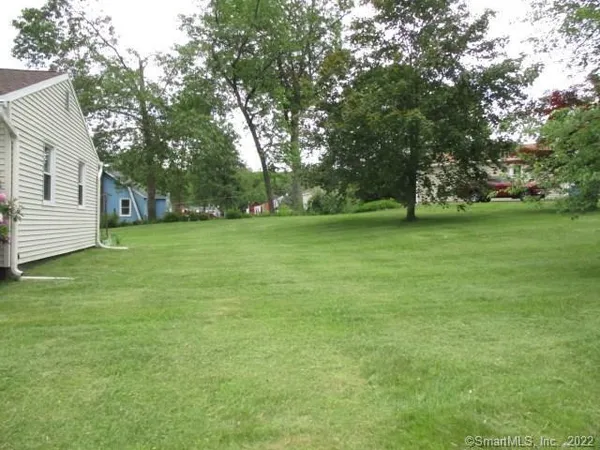 a view of a field of grass and trees