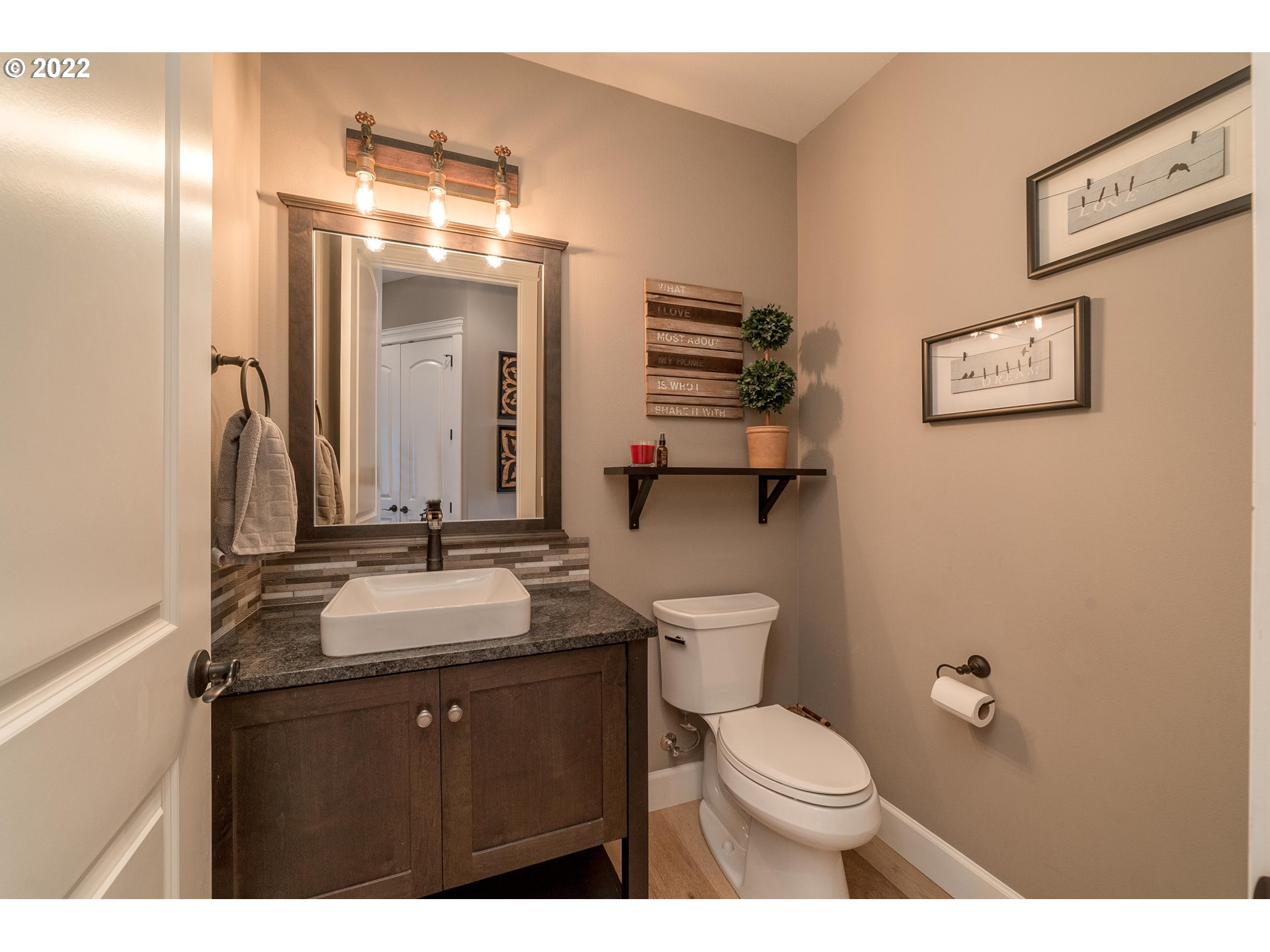 17608 Northeast 26th Avenue Ridgefield, WA 98642 - Photo 12 of 29 a bathroom with a granite countertop sink mirror vanity and toilet