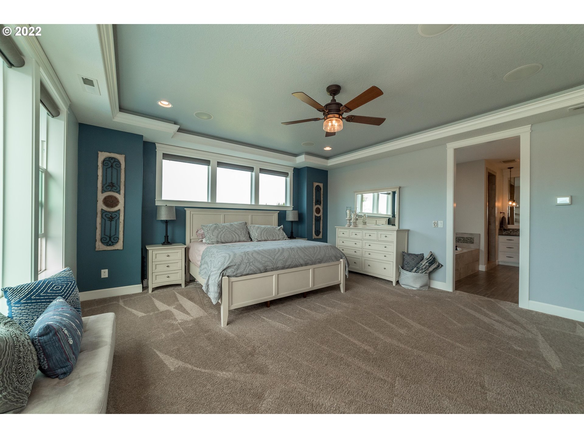17608 Northeast 26th Avenue Ridgefield, WA 98642 - Photo 15 of 29 a spacious bedroom with a large bed and a chandelier