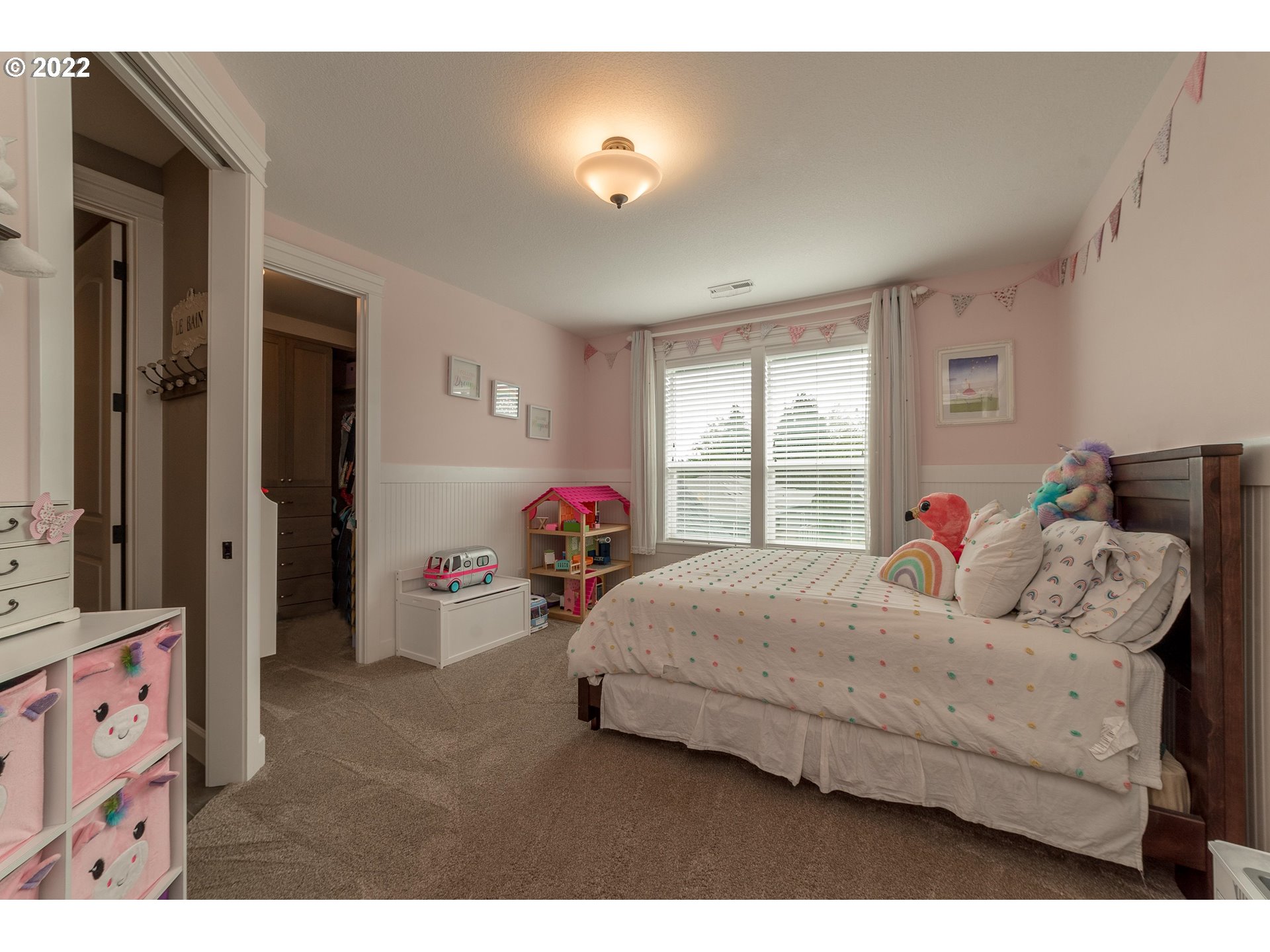 17608 Northeast 26th Avenue Ridgefield, WA 98642 - Photo 21 of 29 a bedroom with a bed and a chandelier