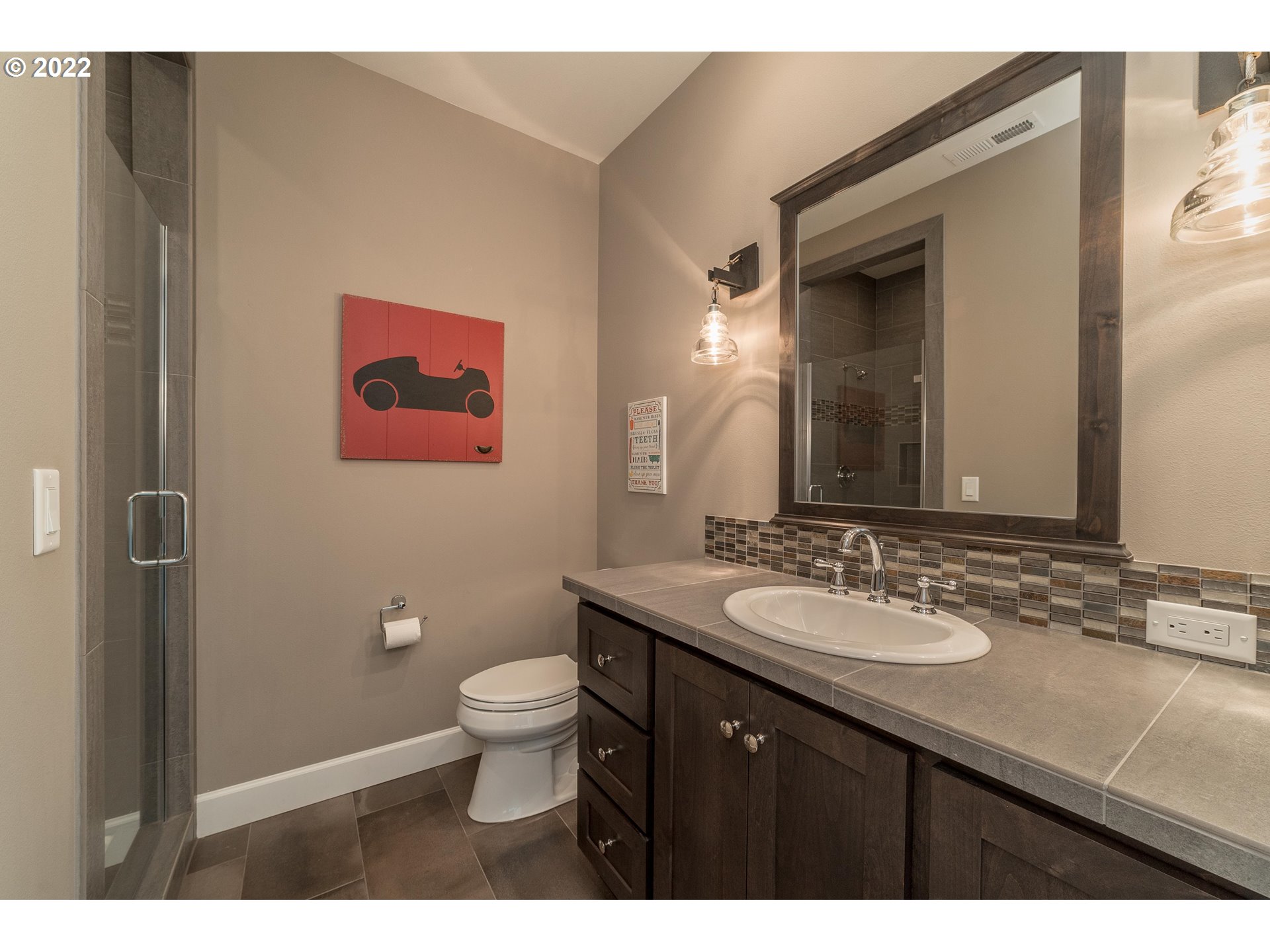 17608 Northeast 26th Avenue Ridgefield, WA 98642 - Photo 24 of 29 a bathroom with a granite countertop toilet a sink and a mirror