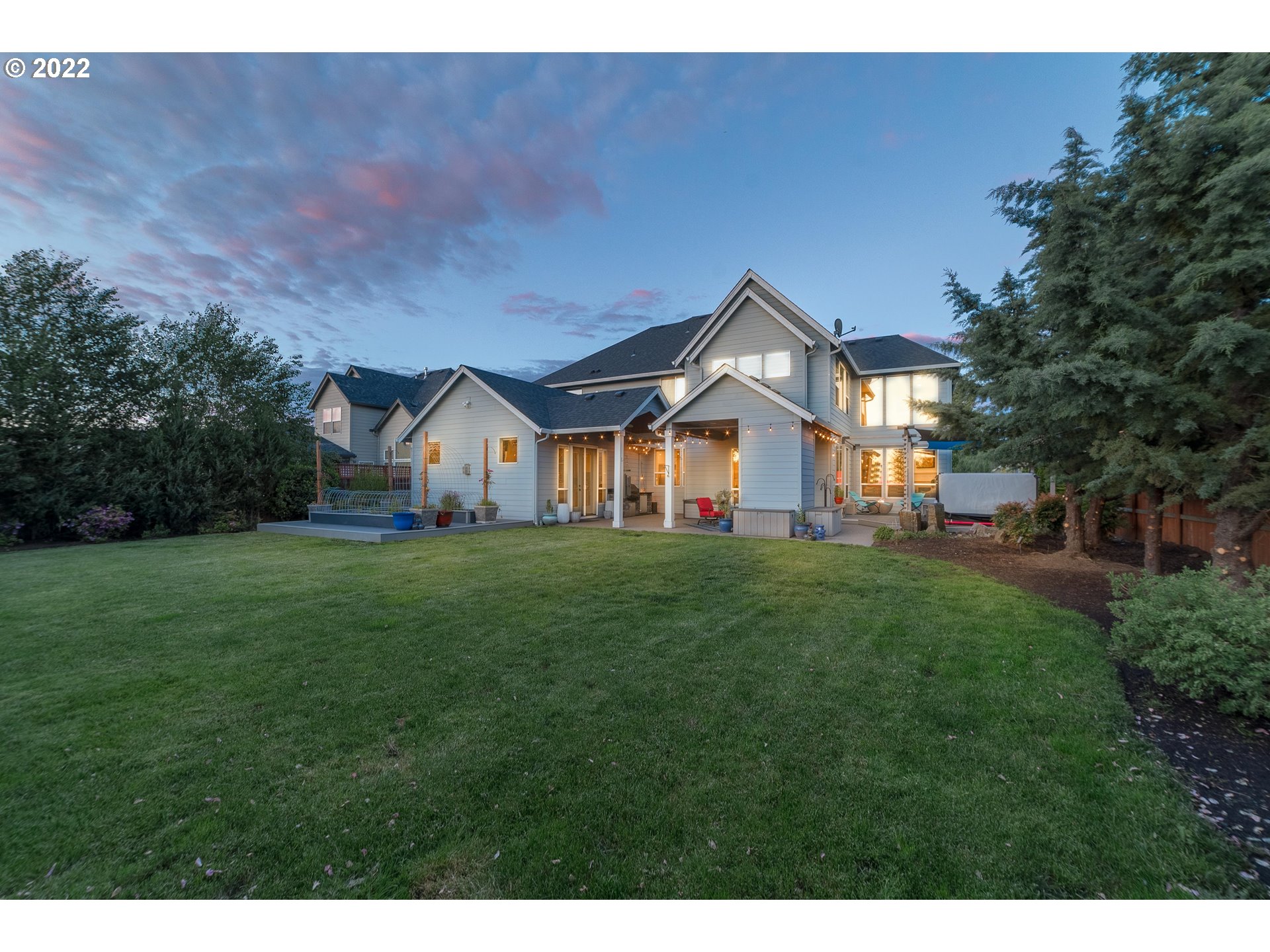 17608 Northeast 26th Avenue Ridgefield, WA 98642 - Photo 29 of 29 a view of a white house in front of a big yard with plants and large trees