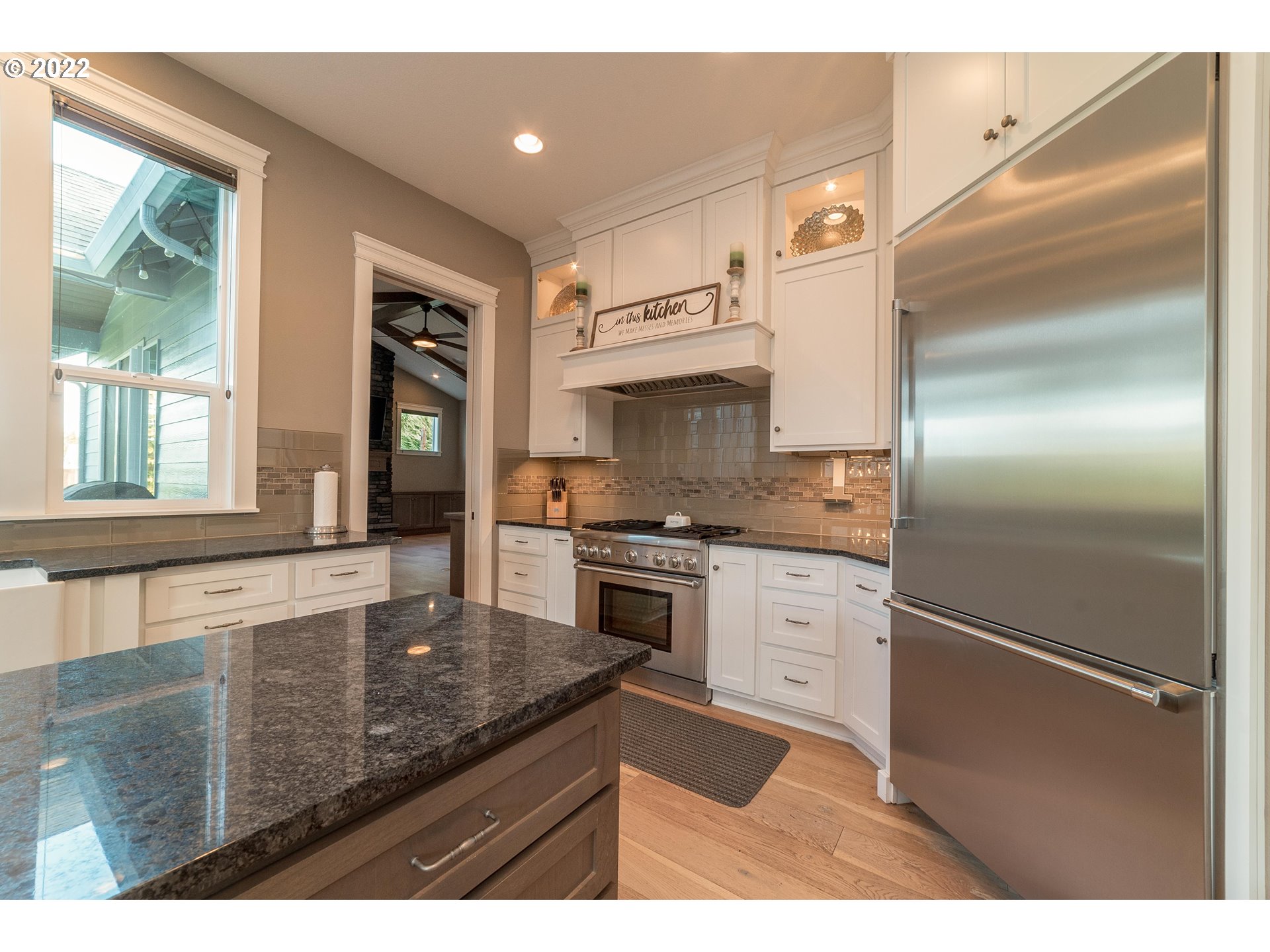 17608 Northeast 26th Avenue Ridgefield, WA 98642 - Photo 8 of 29 a kitchen with stainless steel appliances granite countertop a refrigerator a stove and a sink with large window