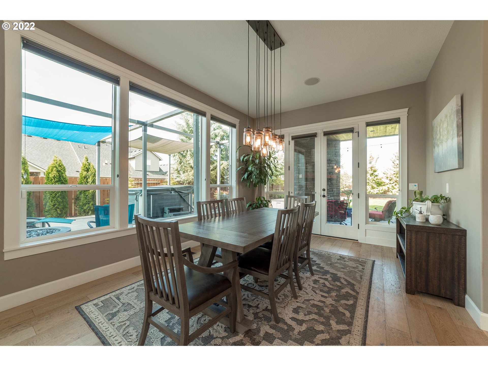17608 Northeast 26th Avenue Ridgefield, WA 98642 - Photo 9 of 29 a dining room with furniture a chandelier and wooden floor