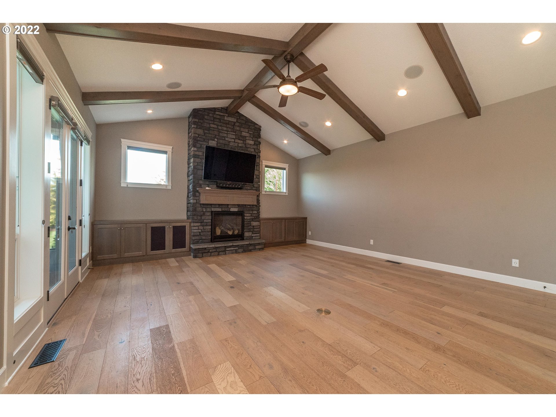 17608 Northeast 26th Avenue Ridgefield, WA 98642 - Photo 10 of 29 an empty room with wooden floor and a ceiling fan