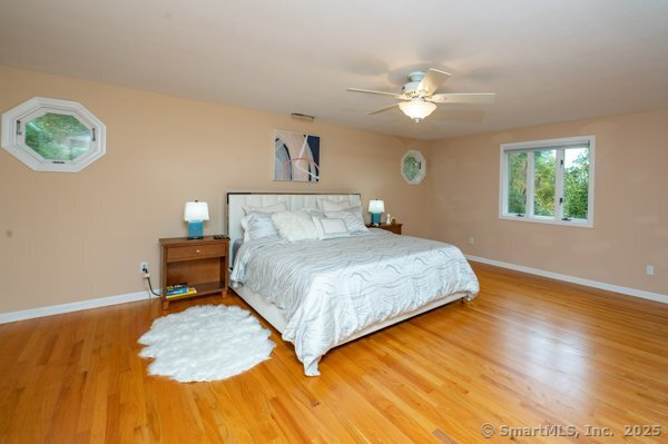 85 Inverness Court Cheshire, CT 06410 - Photo 25 of 40 a bedroom with a bed and a chandelier