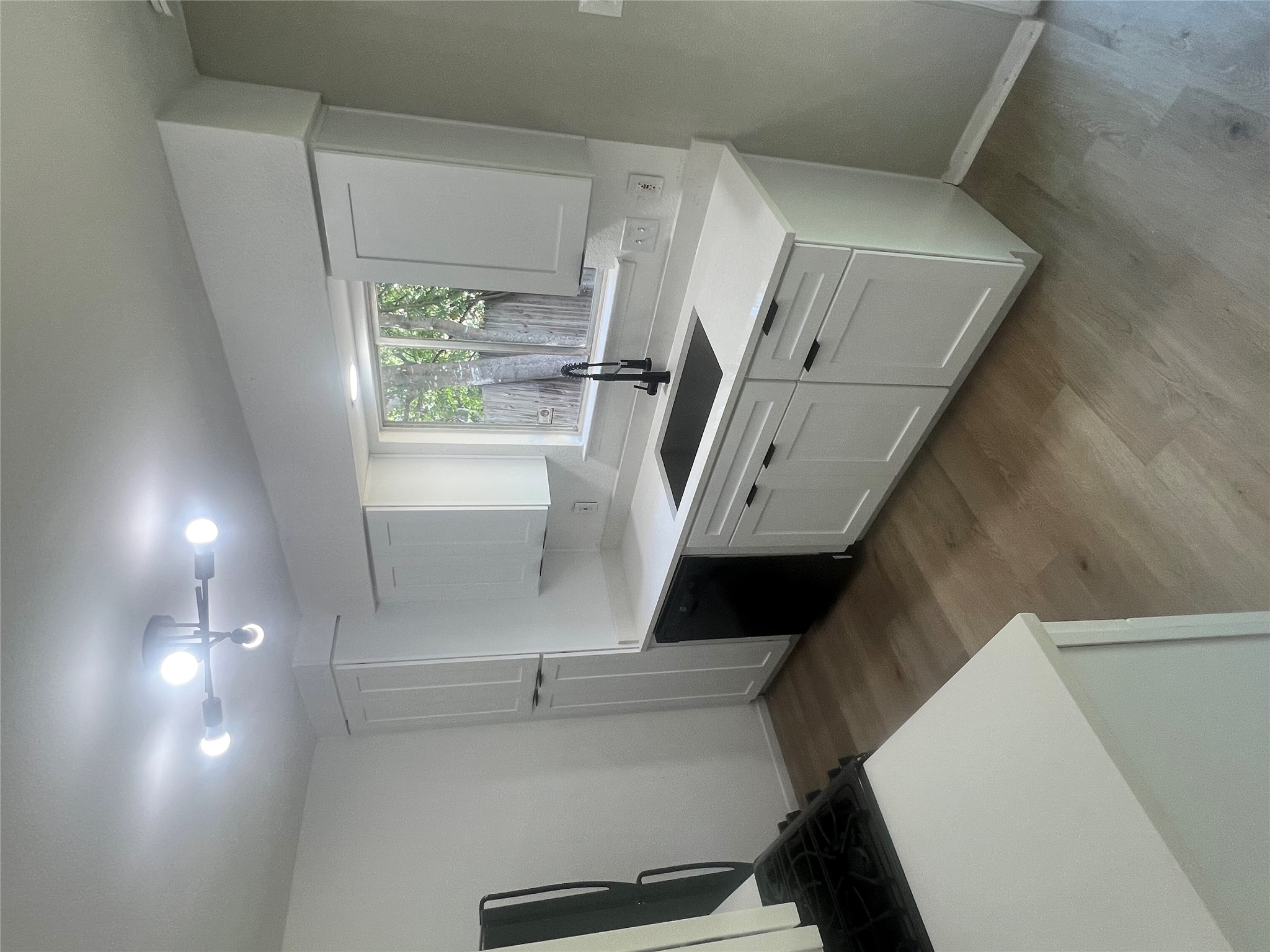 4620 Button Bend Road Austin, TX 78744 - Photo 8 of 22 A well-appointed kitchen features sleek white cabinetry, light countertops, and durable flooring.