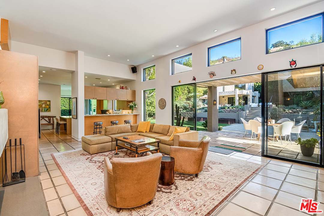 12322 Viewcrest Road Studio City, CA 91604 - Photo 21 of 23 a living room with fireplace furniture and large windows