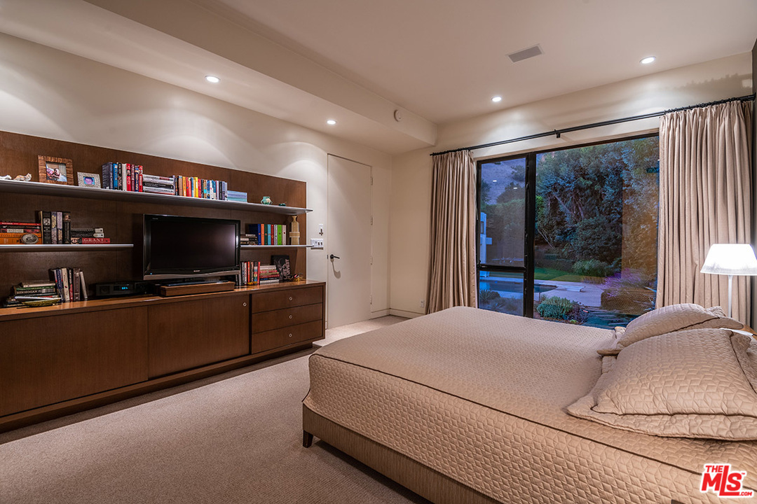 12322 Viewcrest Road Studio City, CA 91604 - Photo 7 of 23 a bedroom with a bed and a flat screen tv