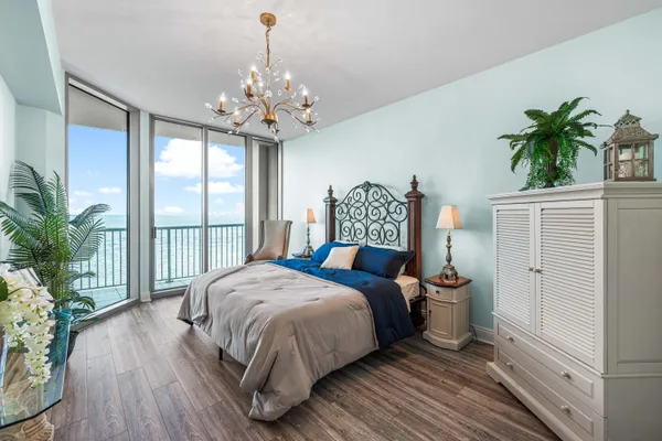 a bedroom with a large bed and a large window