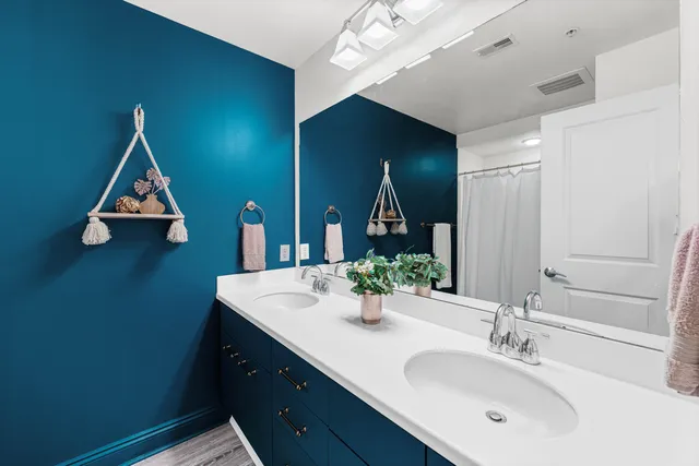 a bathroom with a sink vanity and a mirror