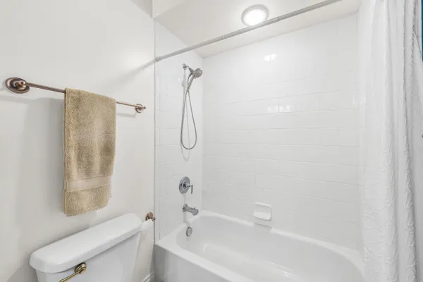 a bathroom with a shower a toilet and a shower