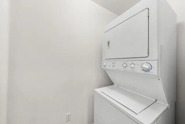 a view of a balcony with chairs and wooden floor