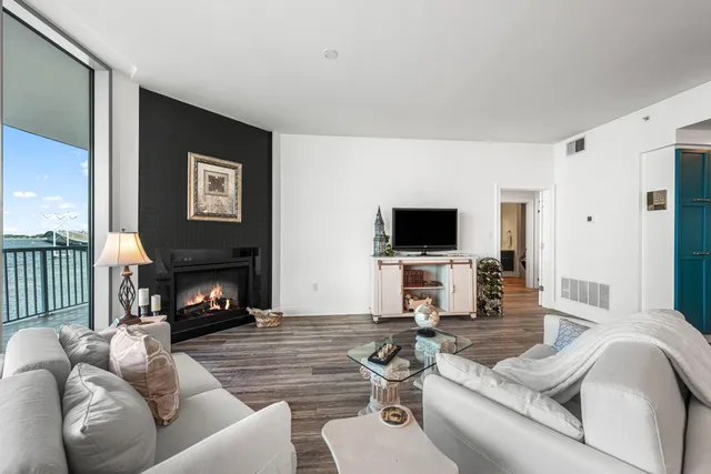 a living room with furniture a flat screen tv and a fireplace