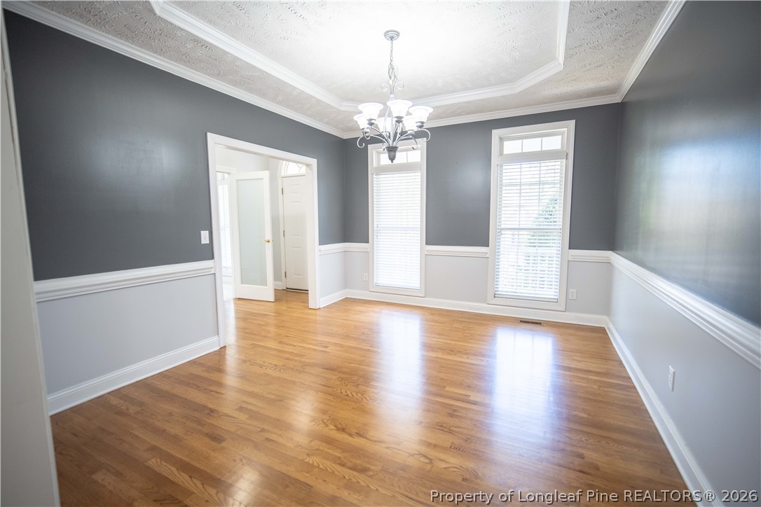 6826 Surrey Road Fayetteville, NC 28306 - Photo 12 of 50 a view of an empty room with window and wooden floor