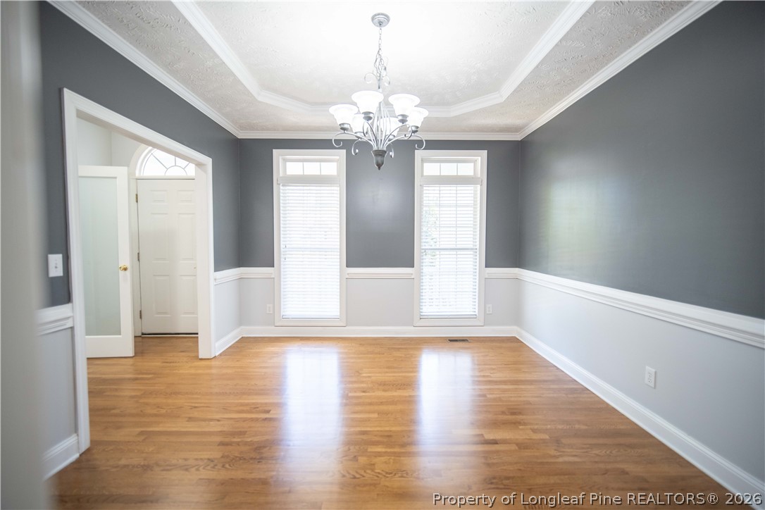 6826 Surrey Road Fayetteville, NC 28306 - Photo 13 of 50 a view of an empty room with wooden floor and a window
