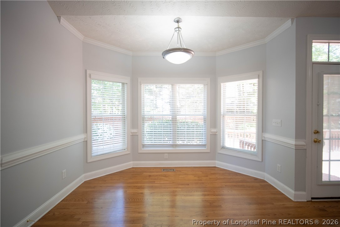 6826 Surrey Road Fayetteville, NC 28306 - Photo 19 of 50 a view of an empty room with wooden floor and a window