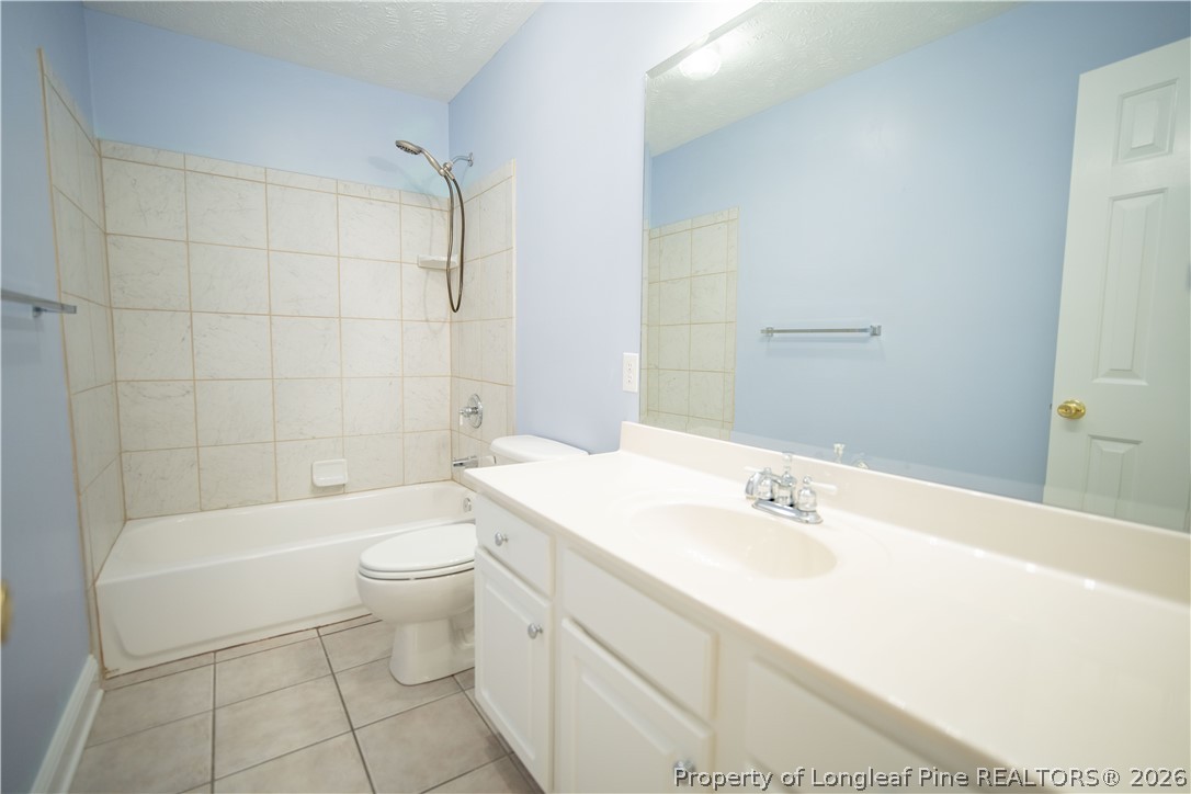 6826 Surrey Road Fayetteville, NC 28306 - Photo 41 of 50 a bathroom with a sink a toilet and shower