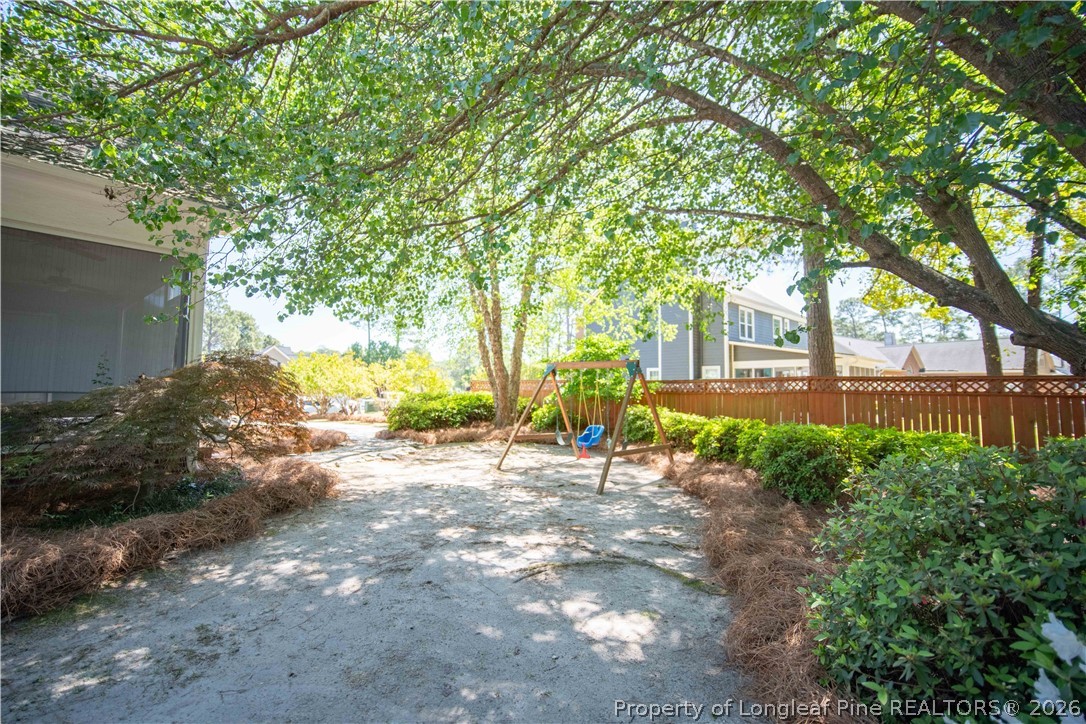 6826 Surrey Road Fayetteville, NC 28306 - Photo 46 of 50 a view of a yard with plants and a large tree