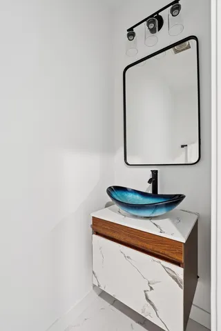 a bathroom with a sink and mirror