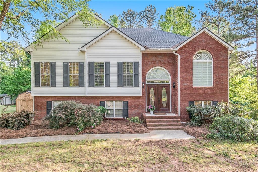 7979 Hannah Road Winston, GA 30187 - Photo 1 of 1 a front view of a house with garden