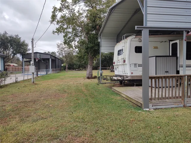 a view of a house with backyard and a tree