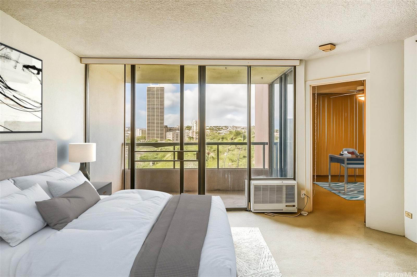 5333 Likini Street, Unit 703 Honolulu, HI 96818 - Photo 3 of 19 a bedroom with a bed and a large window