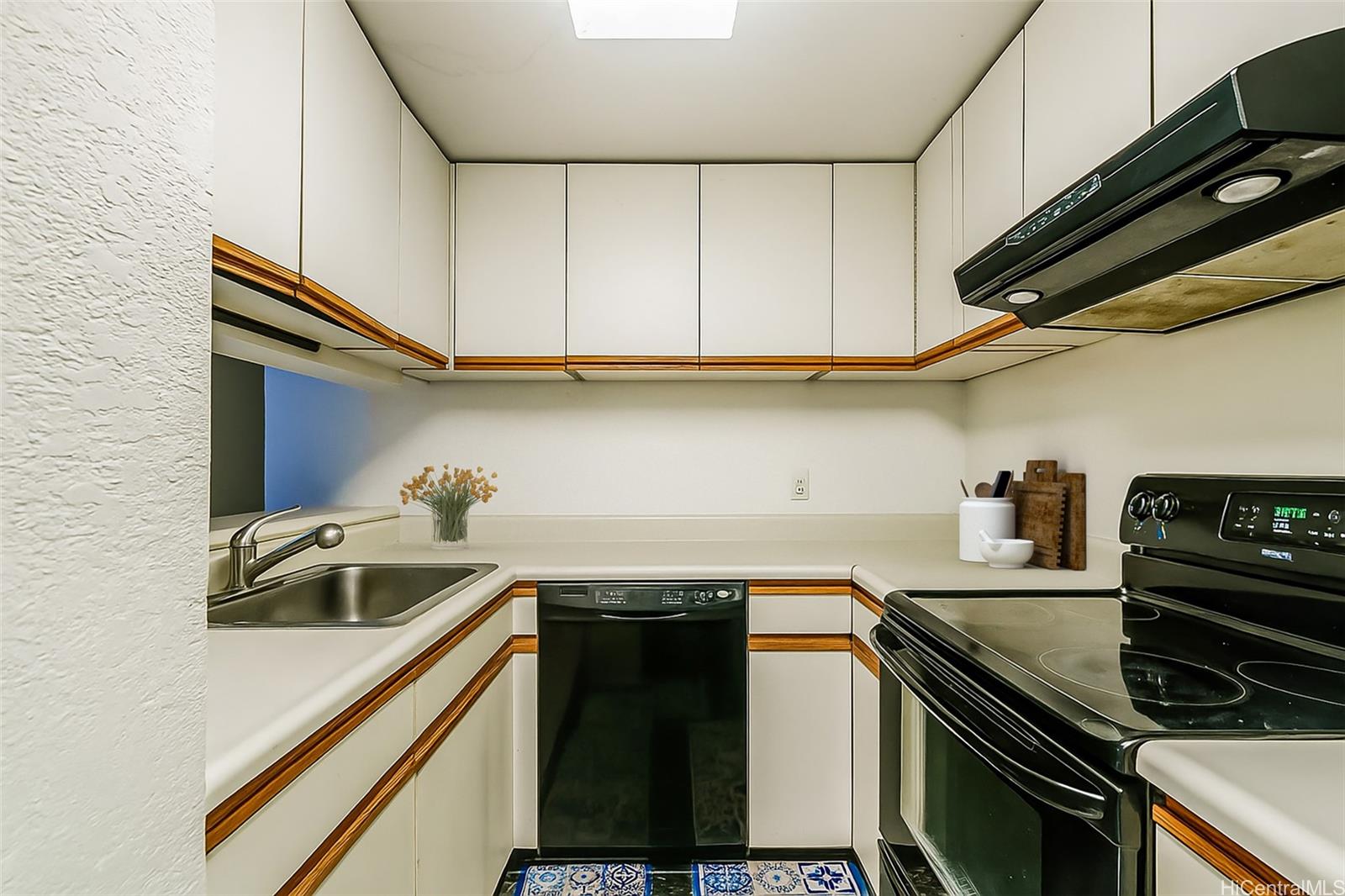 5333 Likini Street, Unit 703 Honolulu, HI 96818 - Photo 4 of 19 a kitchen with a sink and cabinets