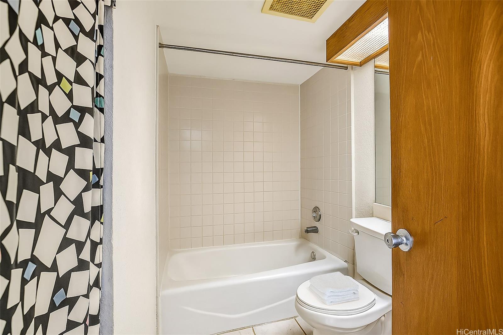 5333 Likini Street, Unit 703 Honolulu, HI 96818 - Photo 7 of 19 a bathroom with a bathtub and shower