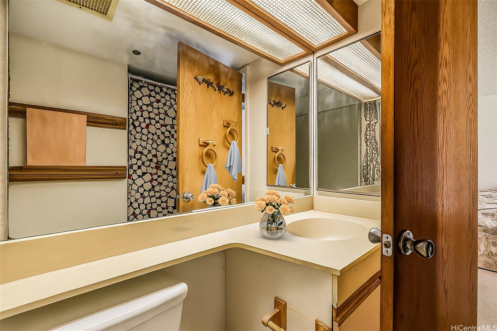 5333 Likini Street, Unit 703 Honolulu, HI 96818 - Photo 8 of 19 a bathroom with a sink and a mirror