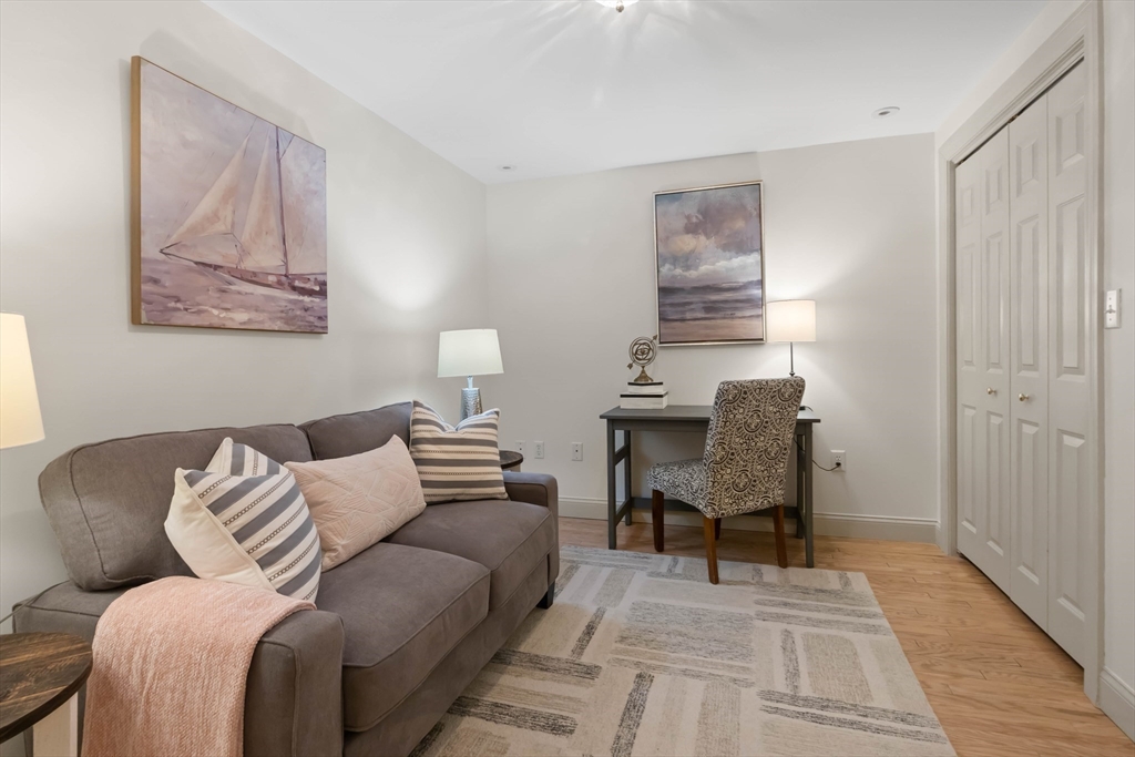 60 Merrimac Street, Unit 907 Amesbury, MA 01913 - Photo 16 of 23 a living room with furniture and wooden floor